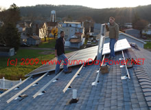 Solar Panels Getting Installed on UniRac Rails with Mounts Flashed into New Roof.